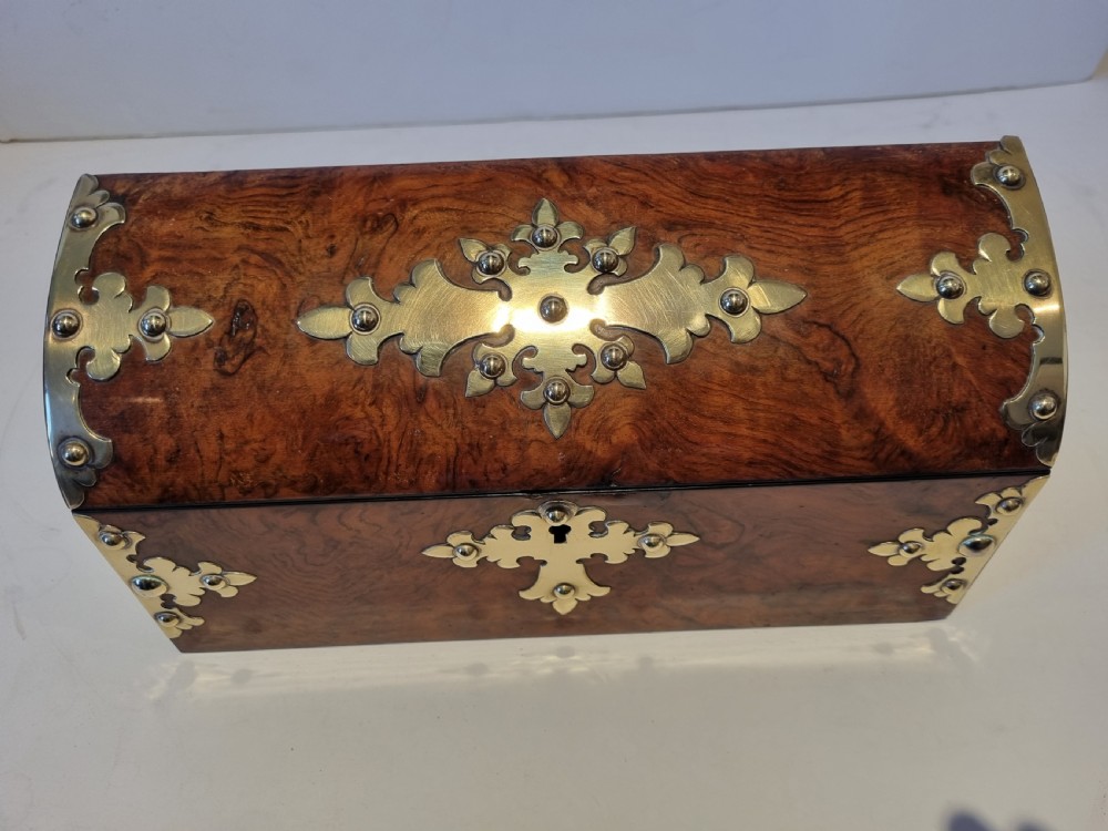 A Victorian burr walnut stationery box with a dome lid, ornamented with pierced brass mounts and a decorative brass keyhole escutcheon. View VIII