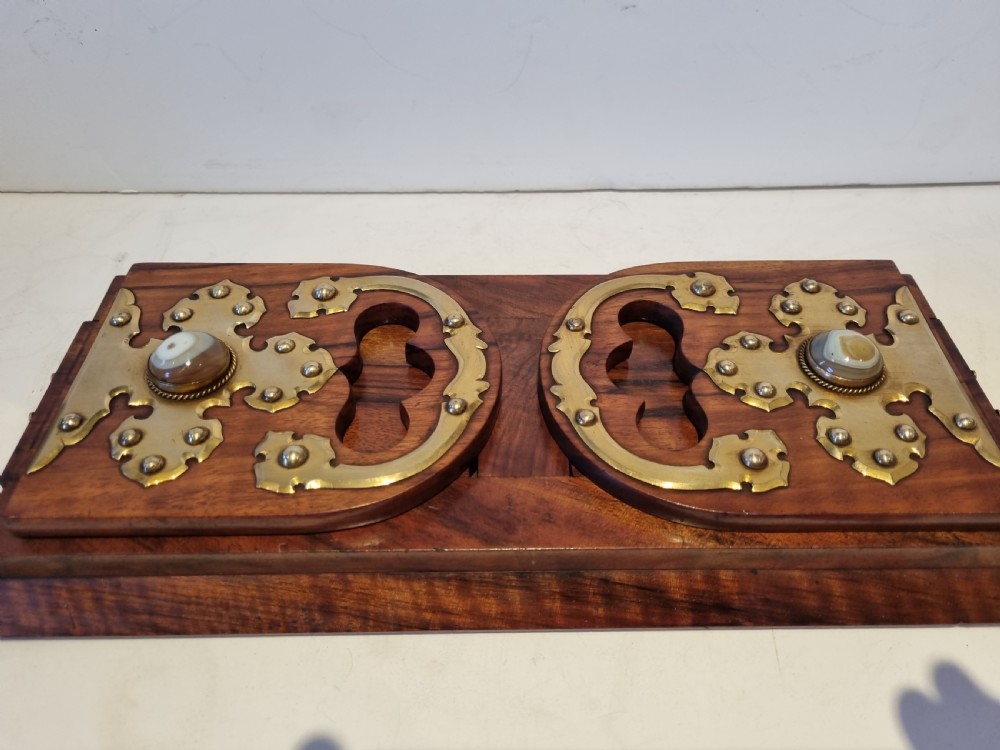 A Victorian walnut expanding book slide featuring hinged arched ends ornamented with pierced brass gothic strapwork and inset agate cabochons. View II