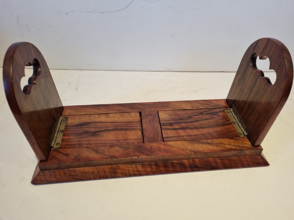 A Victorian walnut expanding book slide featuring hinged arched ends ornamented with pierced brass gothic strapwork and inset agate cabochons. View III