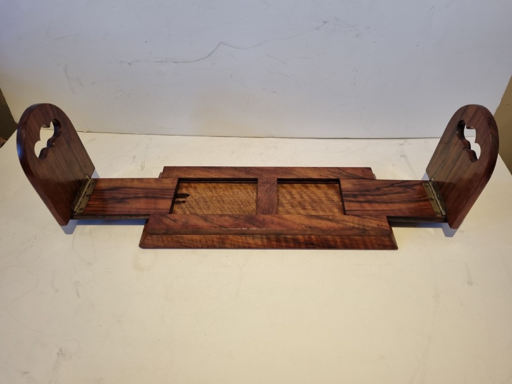 A Victorian walnut expanding book slide featuring hinged arched ends ornamented with pierced brass gothic strapwork and inset agate cabochons. View V