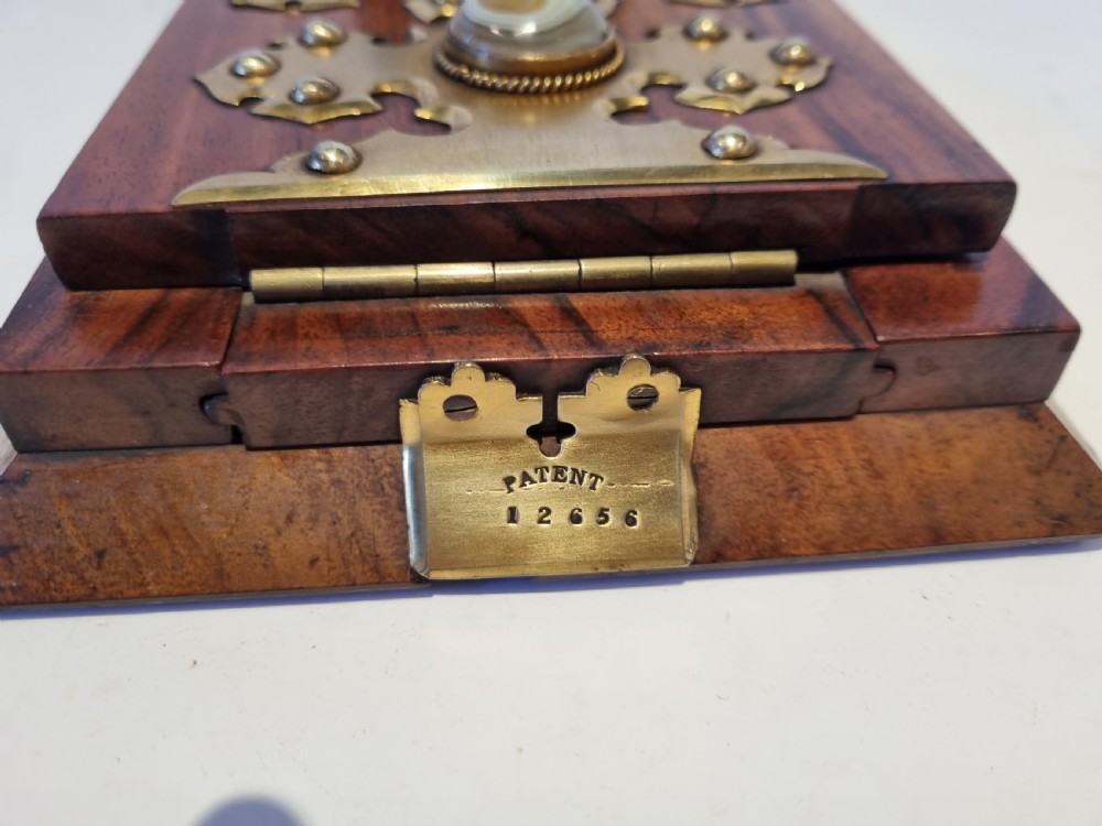 A Victorian walnut expanding book slide featuring hinged arched ends ornamented with pierced brass gothic strapwork and inset agate cabochons. View VII