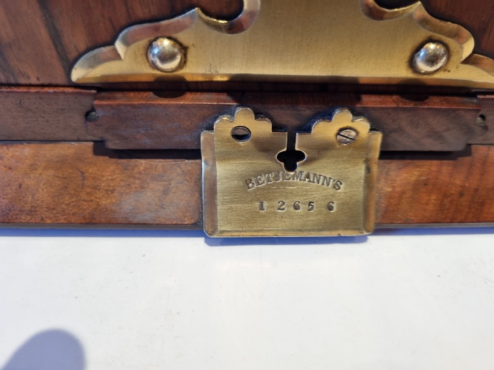 A Victorian walnut expanding book slide featuring hinged arched ends ornamented with pierced brass gothic strapwork and inset agate cabochons. View VIII