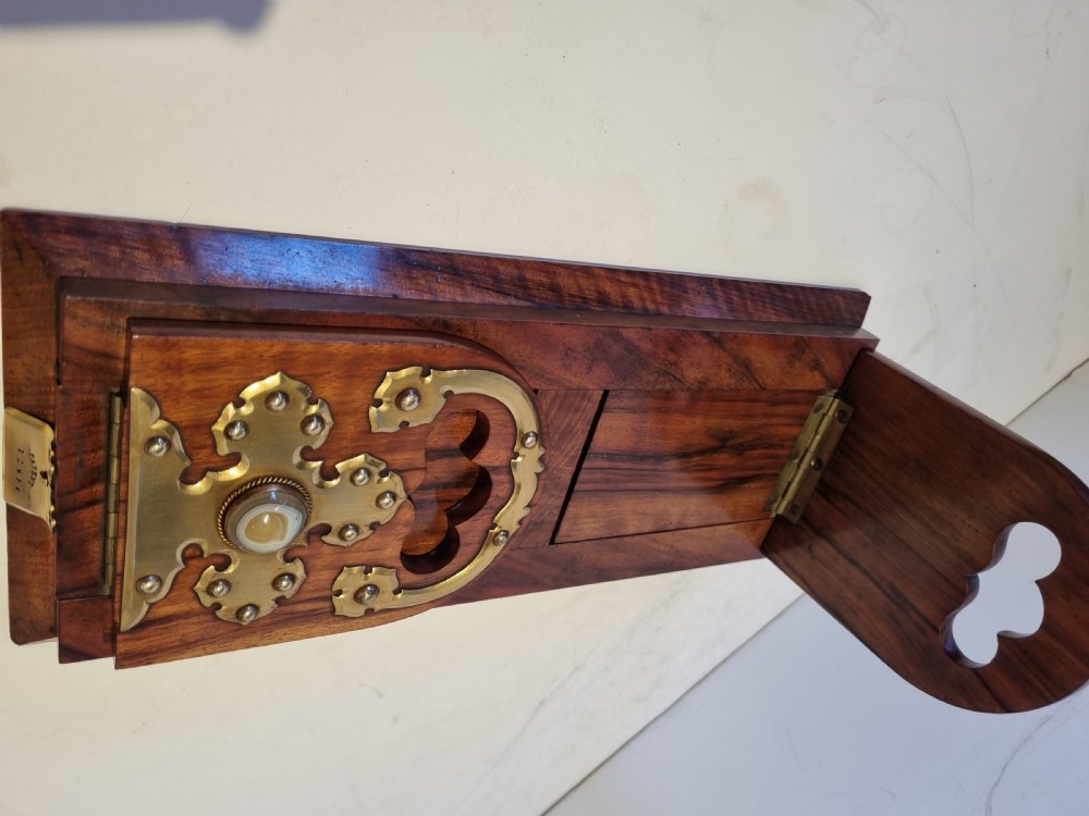 A Victorian walnut expanding book slide featuring hinged arched ends ornamented with pierced brass gothic strapwork and inset agate cabochons. View X