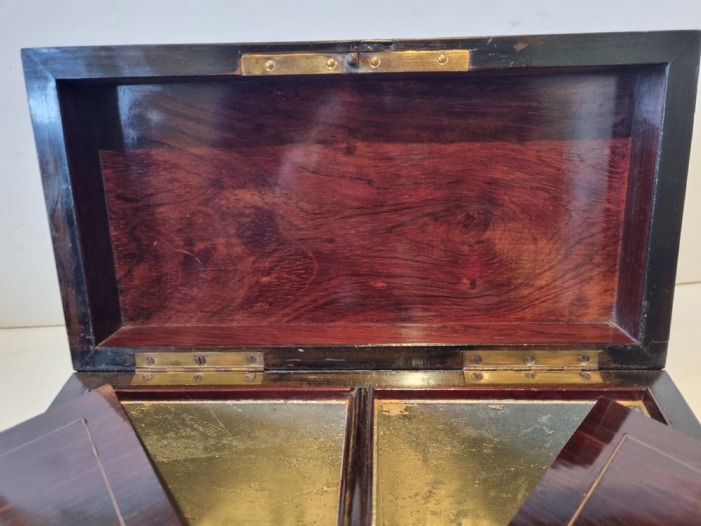 A rectangular ebonised wood tea caddy featuring a lid ornamented with red tortoiseshell and brass Boulle marquetry and a brass-inlaid keyhole escutcheon on the front. View VII