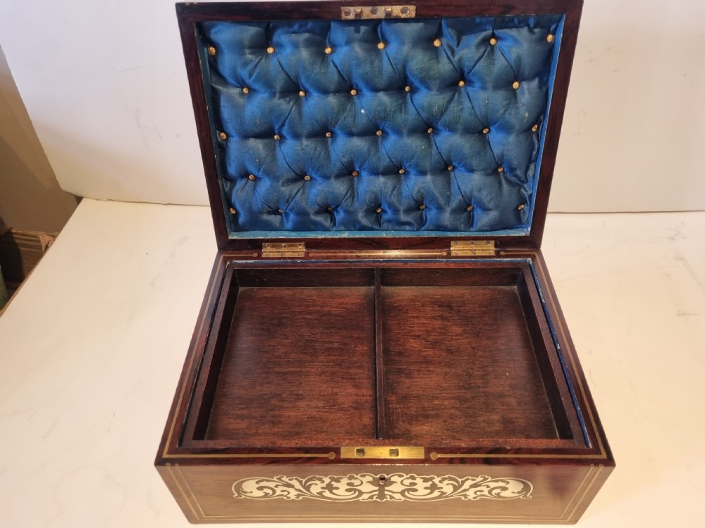 A rectangular dark rosewood box featuring intricate brass floral scrollwork inlay and brass double-stringing on the lid and front panel. View VII