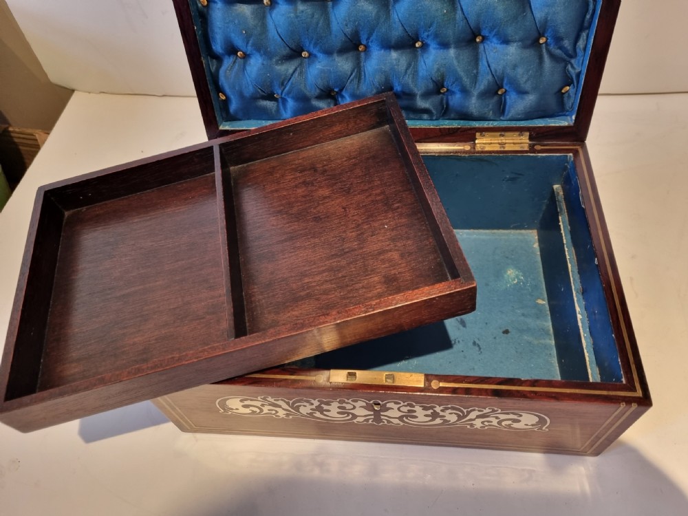 A rectangular dark rosewood box featuring intricate brass floral scrollwork inlay and brass double-stringing on the lid and front panel. View VIII
