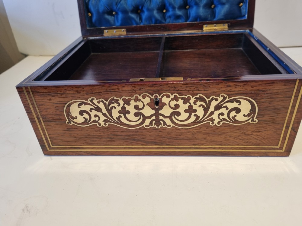 A rectangular dark rosewood box featuring intricate brass floral scrollwork inlay and brass double-stringing on the lid and front panel. View IX