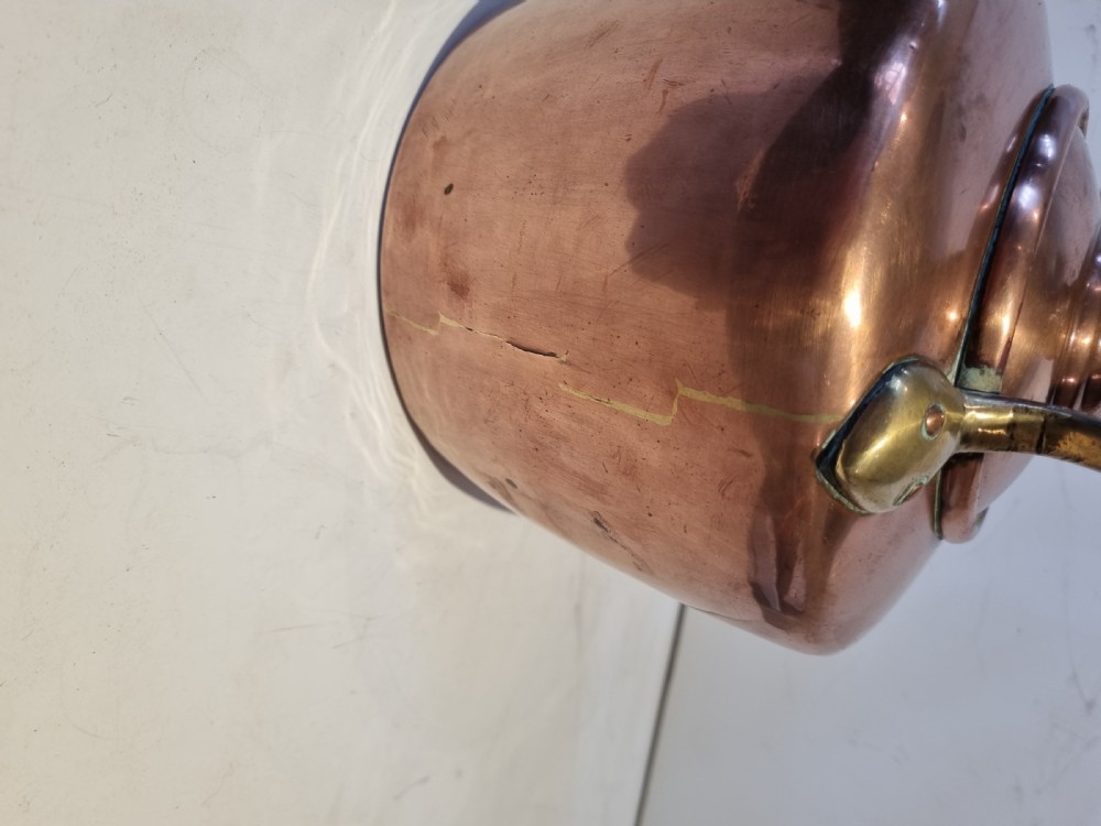 An antique Georgian copper tea kettle featuring a polished body, curved gooseneck spout, domed lid with an acorn finial, and an overhead brass handle. View IV