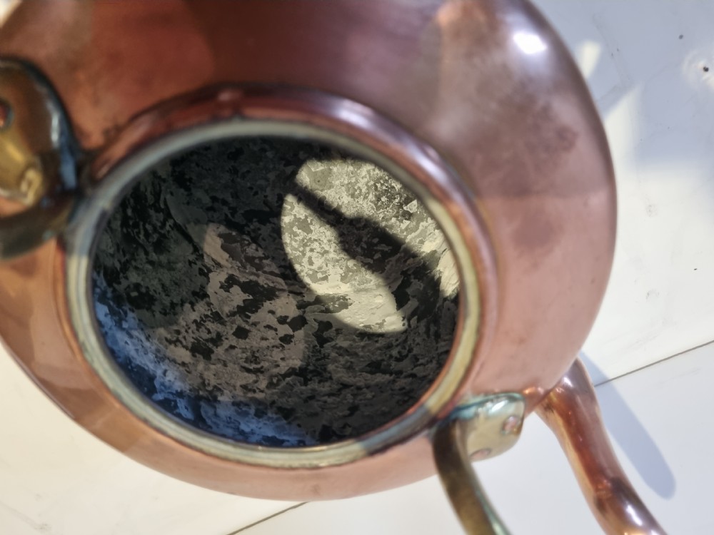 An antique Georgian copper tea kettle featuring a polished body, curved gooseneck spout, domed lid with an acorn finial, and an overhead brass handle. View V