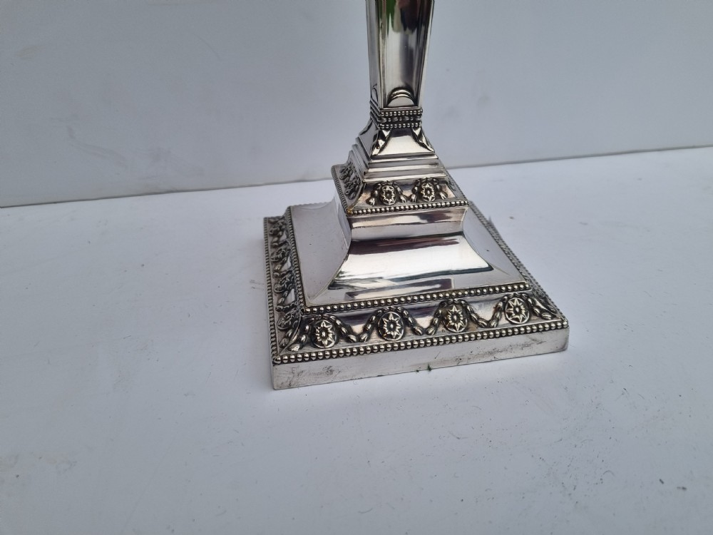 A Victorian silver-plated table lamp base featuring a square stepped foot, a tapered column shaft, and Neoclassical festoon engravings. View III