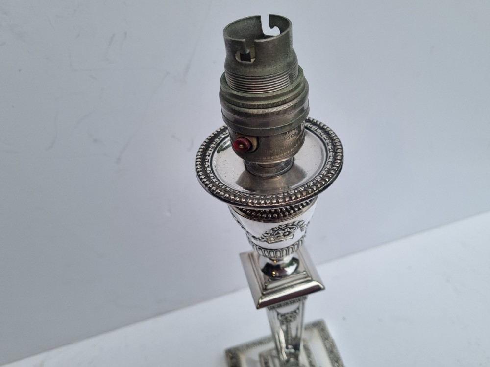 A Victorian silver-plated table lamp base featuring a square stepped foot, a tapered column shaft, and Neoclassical festoon engravings. View VII
