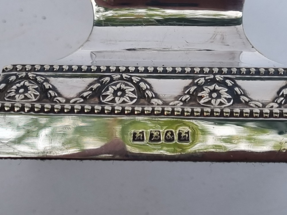 A Victorian silver-plated table lamp base featuring a square stepped foot, a tapered column shaft, and Neoclassical festoon engravings. View VIII