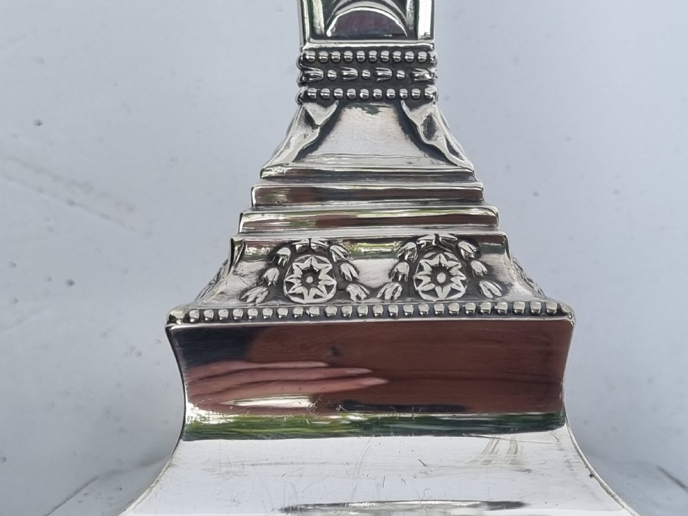 A Victorian silver-plated table lamp base featuring a square stepped foot, a tapered column shaft, and Neoclassical festoon engravings. View IX