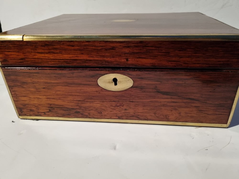 A rectangular dark rosewood document box featuring brass edge binding, an oval brass keyhole escutcheon, and an oval brass top inlay. View II