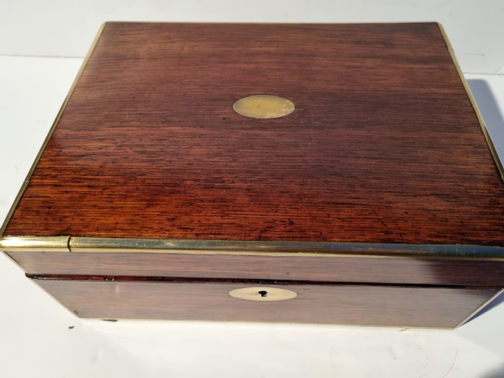 A rectangular dark rosewood document box featuring brass edge binding, an oval brass keyhole escutcheon, and an oval brass top inlay. View III