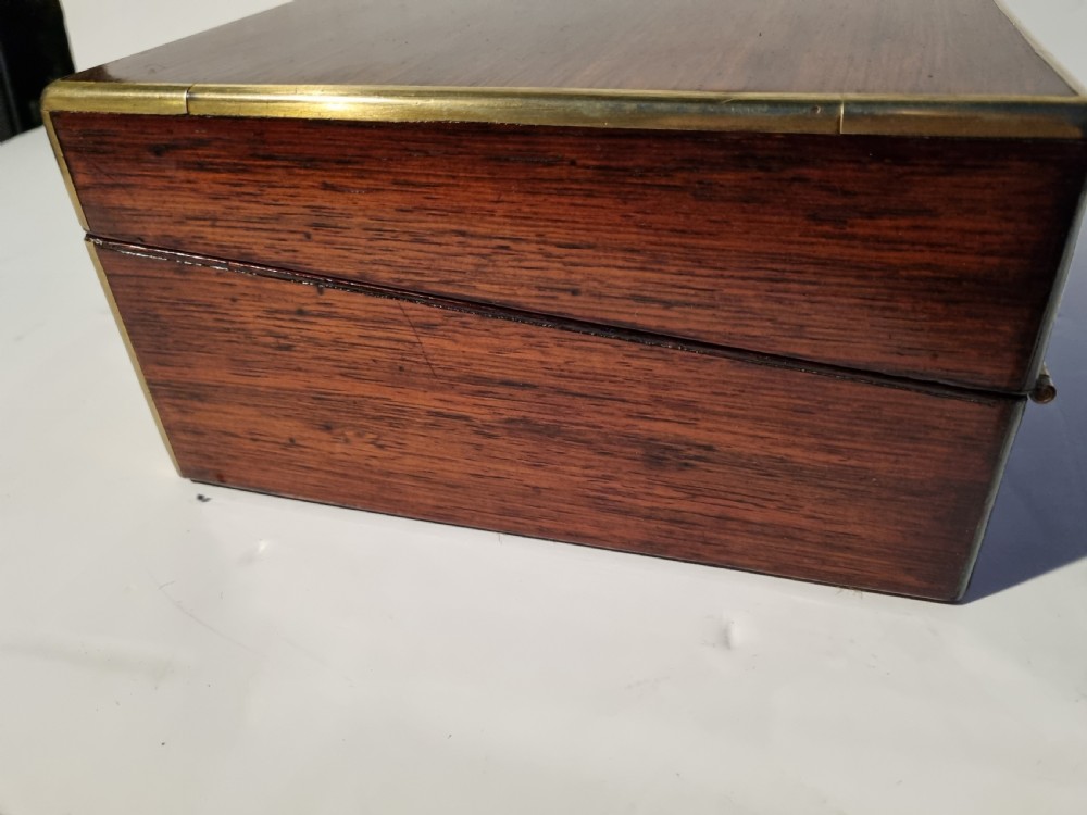 A rectangular dark rosewood document box featuring brass edge binding, an oval brass keyhole escutcheon, and an oval brass top inlay. View IV