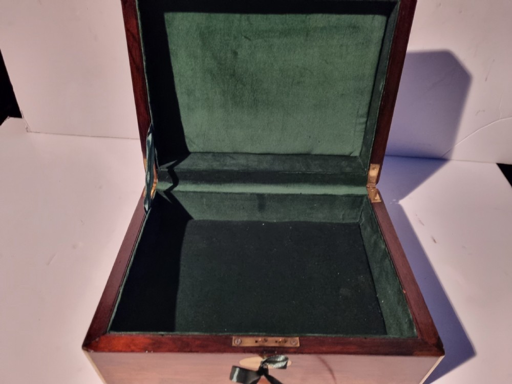 A rectangular dark rosewood document box featuring brass edge binding, an oval brass keyhole escutcheon, and an oval brass top inlay. View VII