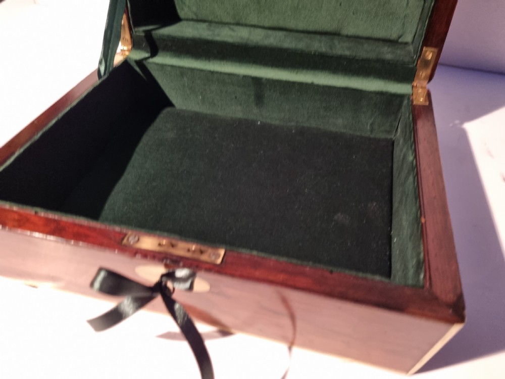 A rectangular dark rosewood document box featuring brass edge binding, an oval brass keyhole escutcheon, and an oval brass top inlay. View VIII