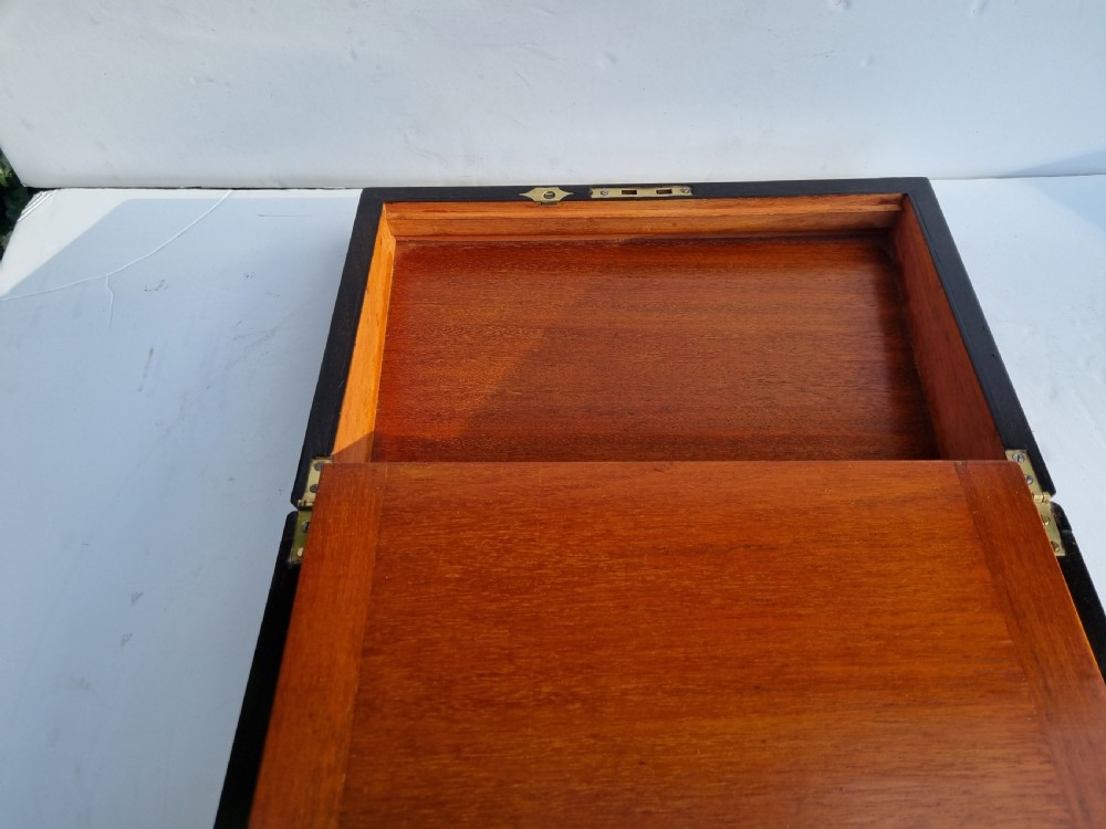 A rectangular Victorian walnut writing box with intricate geometric parquetry inlay borders and a central brass keyhole. View XI
