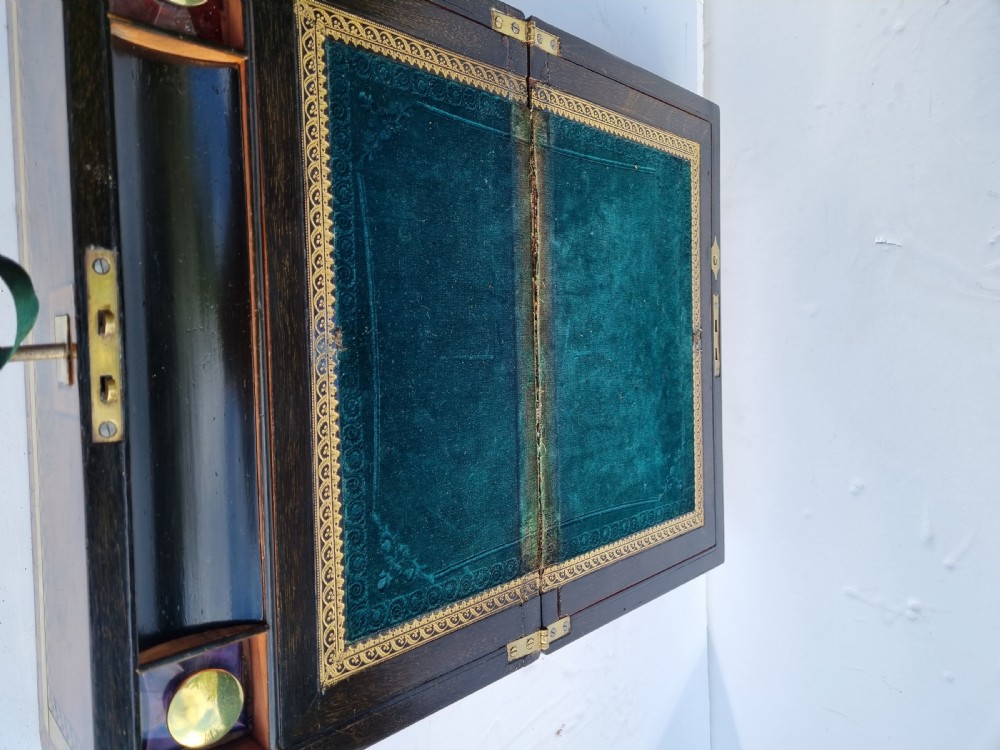 A rectangular Victorian walnut writing box with intricate geometric parquetry inlay borders and a central brass keyhole. View XII