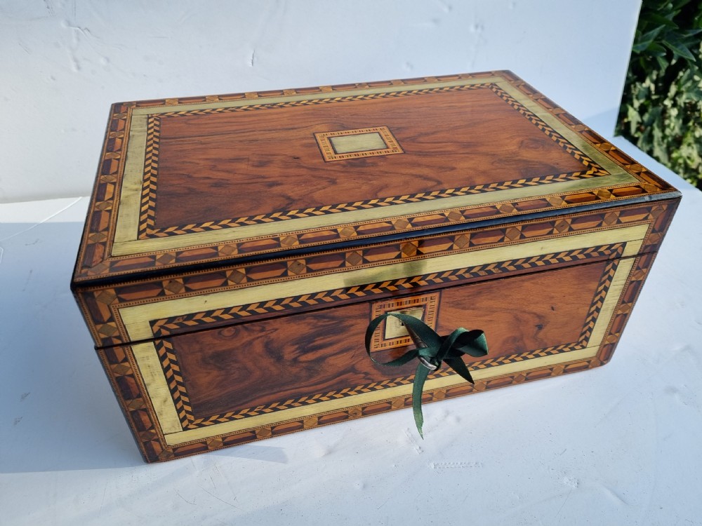A rectangular Victorian walnut writing box with intricate geometric parquetry inlay borders and a central brass keyhole. View XIII