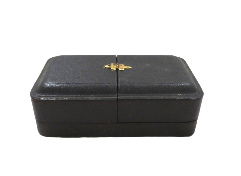 A pair of Victorian engraved sterling silver salt cellars with matching spoons displayed inside an open fitted purple silk-lined presentation case. View VIII