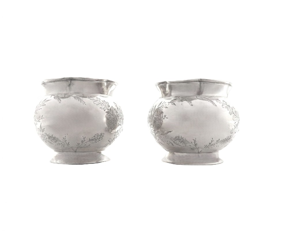 A pair of Victorian engraved sterling silver salt cellars with matching spoons displayed inside an open fitted purple silk-lined presentation case. View IX