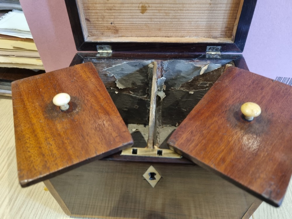 A rectangular dark rosewood tea caddy featuring a lid inlaid with an oval shell motif and a diamond-shaped bone keyhole escutcheon on the front face. View IX