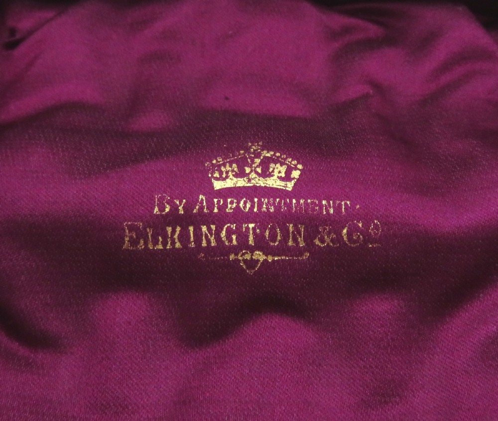 A fitted velvet-lined presentation case containing a set of six cylindrical sterling silver napkin rings decorated with floral engravings. View VIII