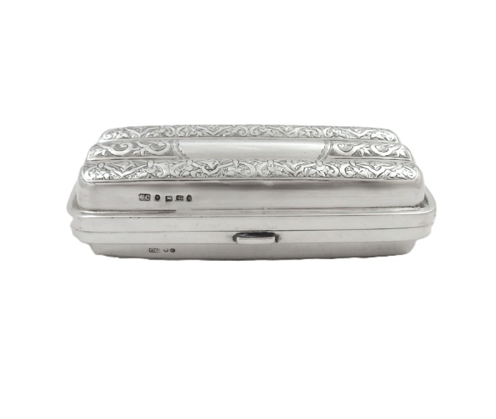 An engraved Victorian sterling silver cigar case featuring three contoured sections and intricate foliate patterns with stamped hallmarks. View IV