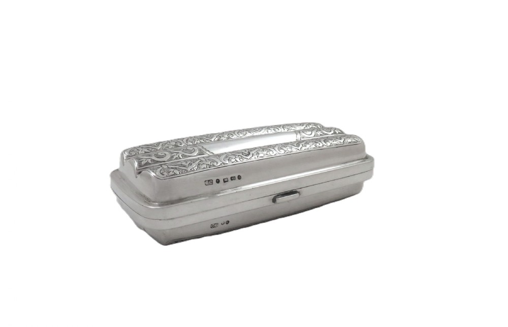 An engraved Victorian sterling silver cigar case featuring three contoured sections and intricate foliate patterns with stamped hallmarks. View VI