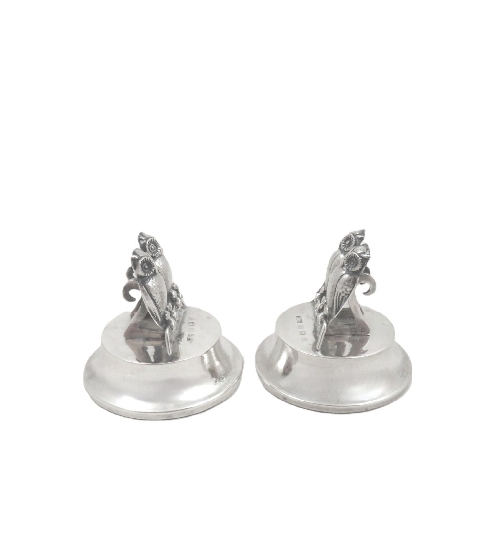 A pair of Edwardian sterling silver menu holders featuring double owl figures perched on round polished bases with visible silver hallmarks. View III