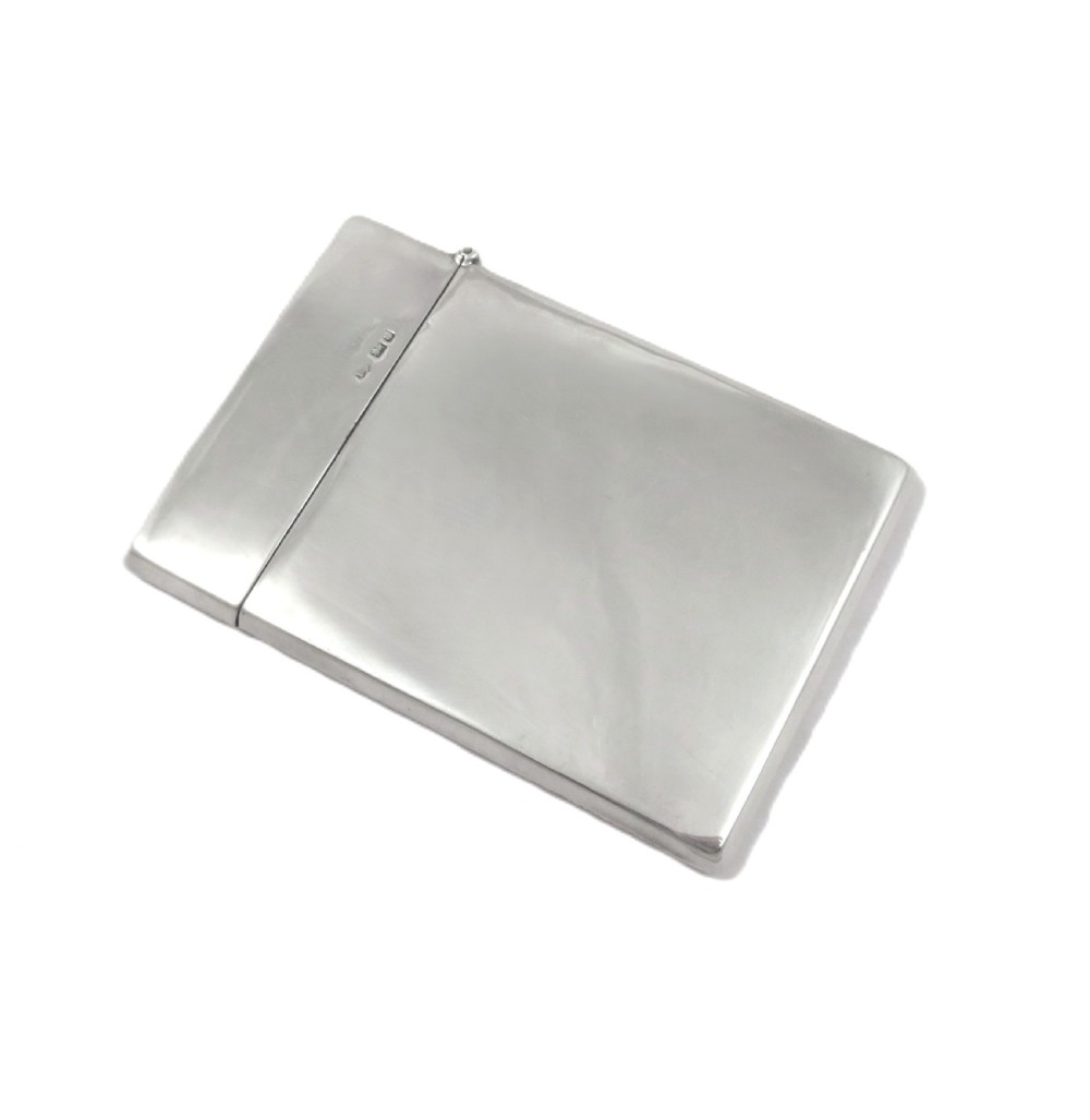 A rectangular Edwardian sterling silver card case decorated with repousse scrollwork and a central relief scene of a hound pursuing a stag. View IV