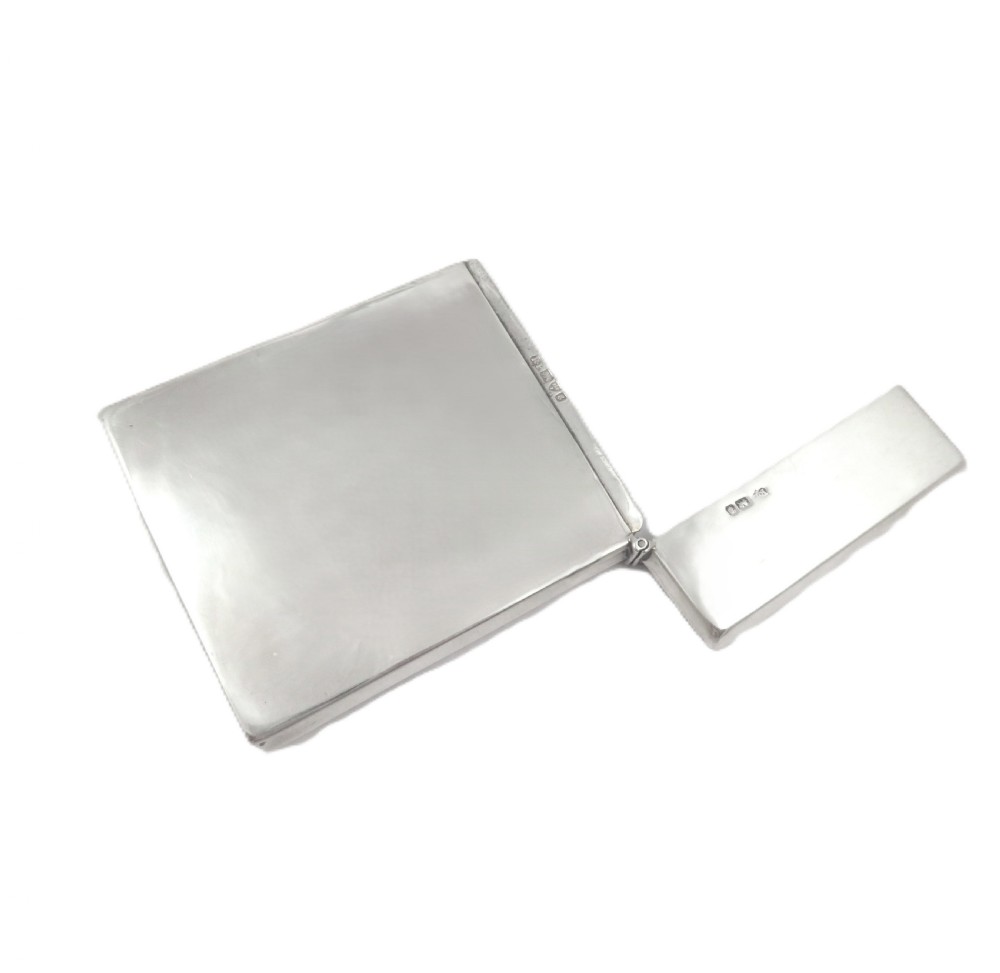 A rectangular Edwardian sterling silver card case decorated with repousse scrollwork and a central relief scene of a hound pursuing a stag. View VI