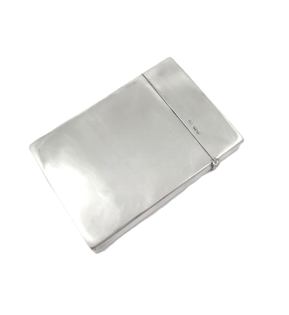 A rectangular Edwardian sterling silver card case decorated with repousse scrollwork and a central relief scene of a hound pursuing a stag. View VII