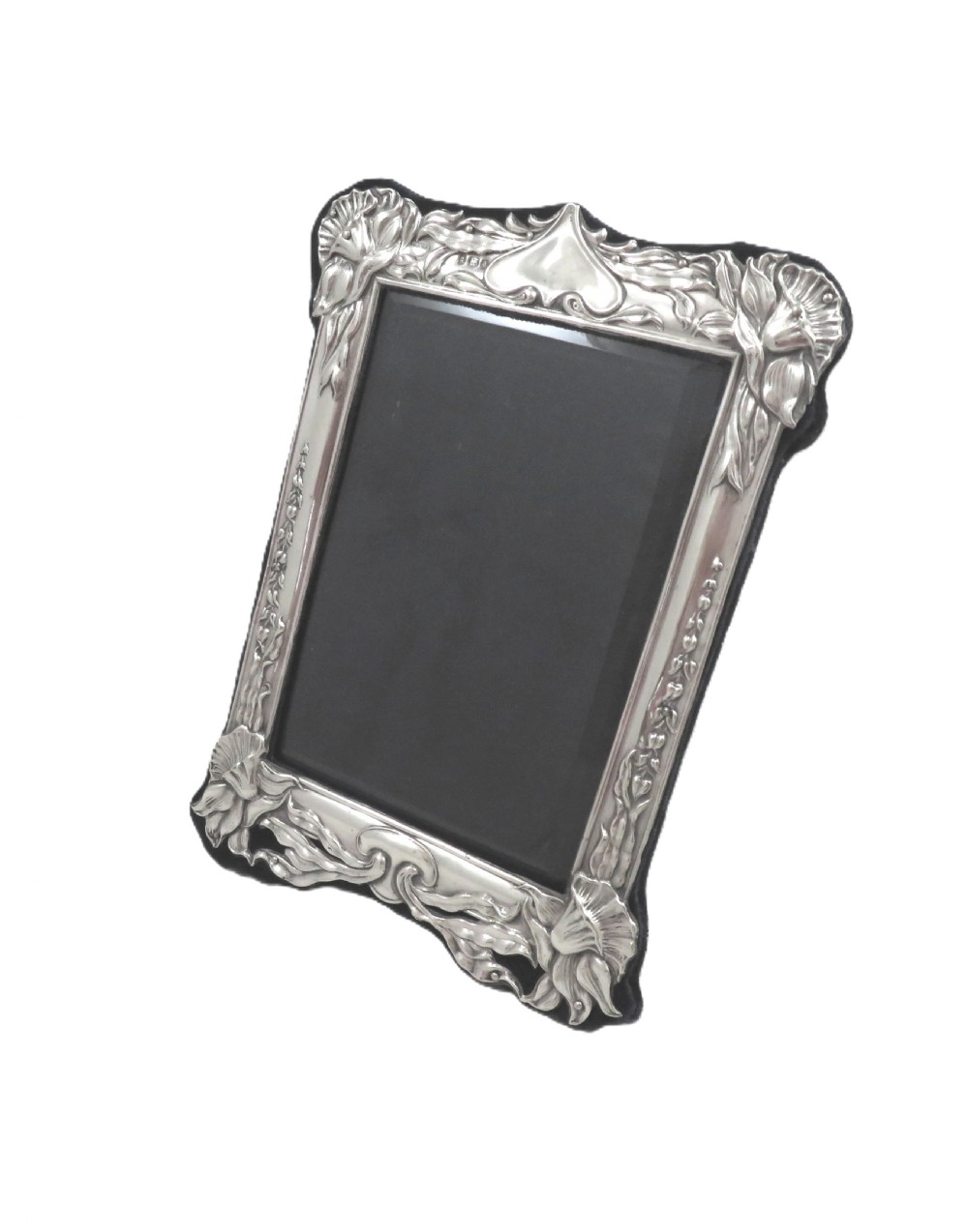 An embossed sterling silver Art Nouveau picture frame featuring stylised floral repousse motifs and a fabric-covered easel backing. View IV