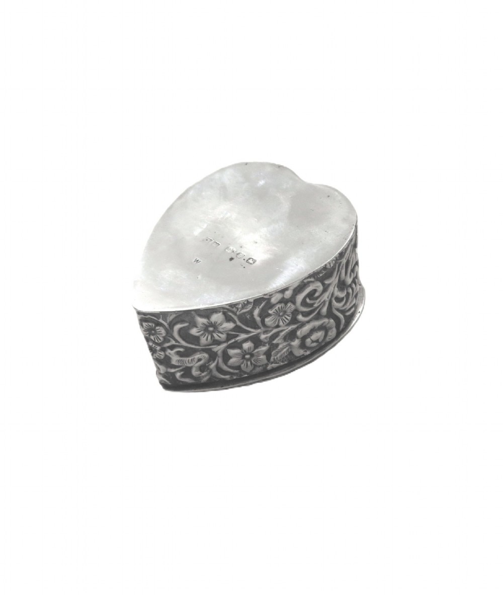 A heart-shaped sterling silver trinket box featuring intricate chased floral motifs and scrollwork. View IV
