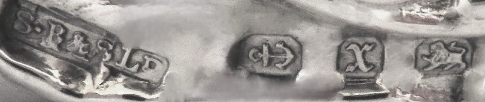 An antique Victorian sterling silver photo frame featuring intricate scrollwork, pierced openwork detail, a rectangular aperture, and a maroon backing. View II
