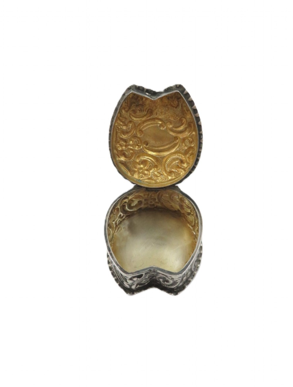 A small horseshoe-shaped sterling silver trinket box featuring embossed floral scrollwork and a central vacant cartouche. View V