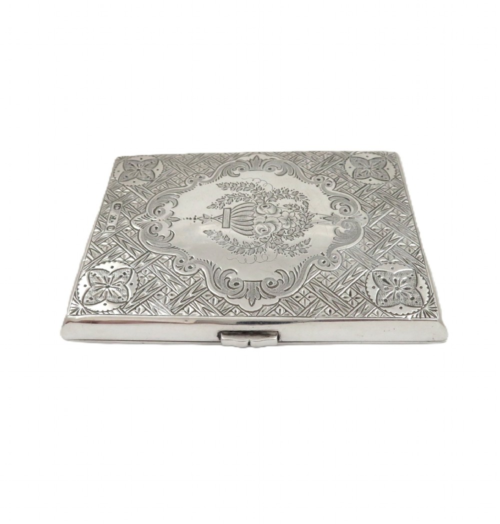 An antique Victorian sterling silver card case featuring geometric engine turning, floral engraving, and British silver hallmarks. View IX