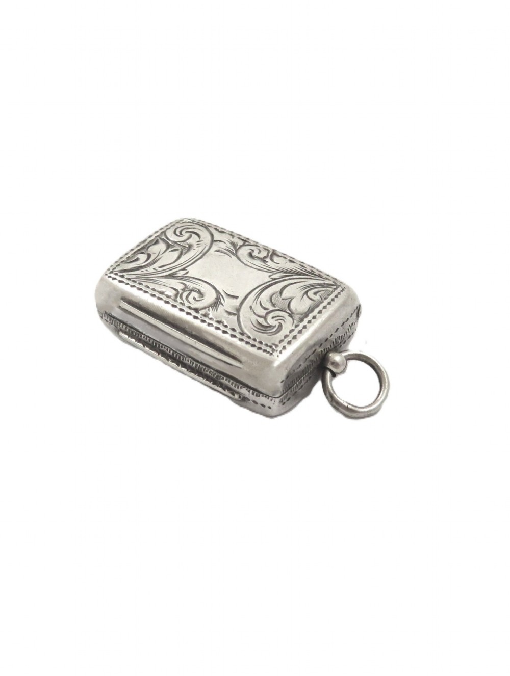 An antique rectangular sterling silver vinaigrette featuring foliate scroll engraving and an attached suspension loop. View VI