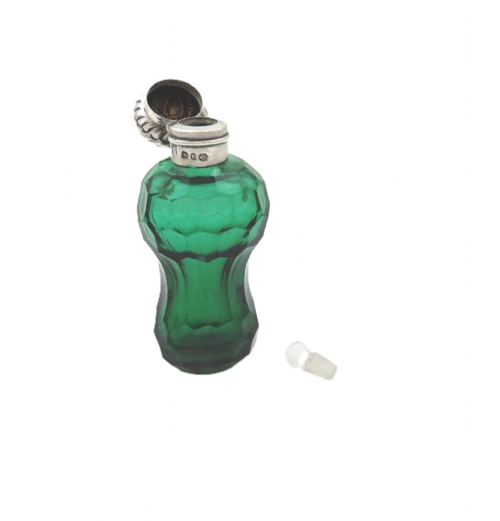 A late Victorian faceted green cut glass scent bottle featuring an engraved sterling silver collar and cap. View II
