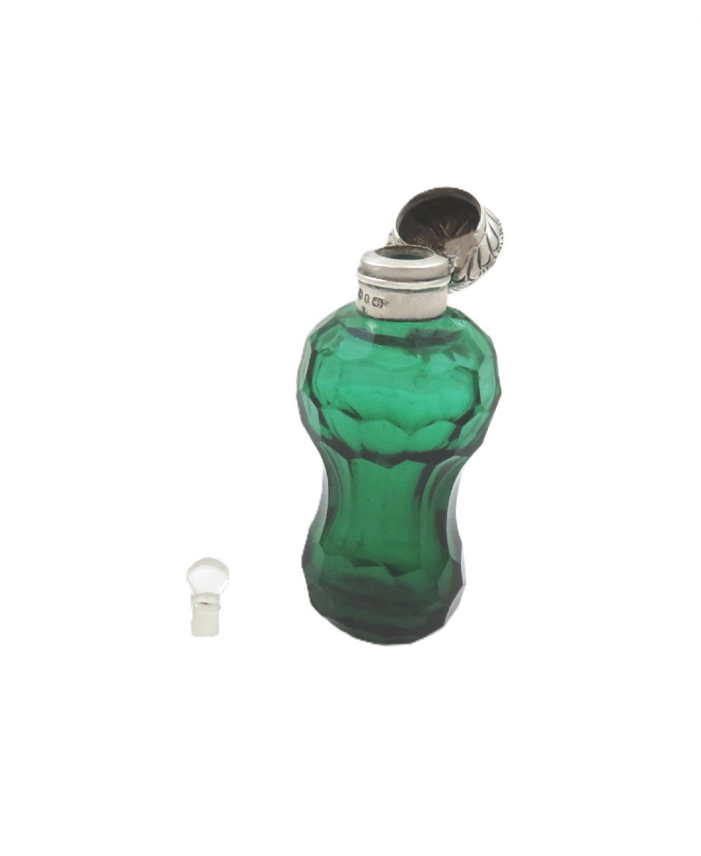 A late Victorian faceted green cut glass scent bottle featuring an engraved sterling silver collar and cap. View VI