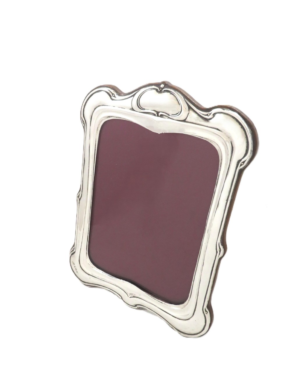 An Art Nouveau sterling silver photo frame with sinuous, organic border detailing and a dark backing. View IV