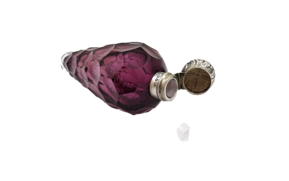 A late Victorian faceted amethyst glass scent bottle featuring an embossed sterling silver collar and top. View III