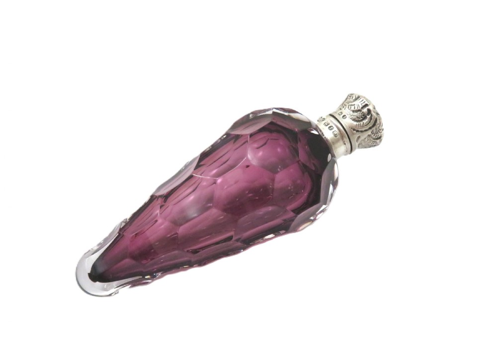 A late Victorian faceted amethyst glass scent bottle featuring an embossed sterling silver collar and top. View VII