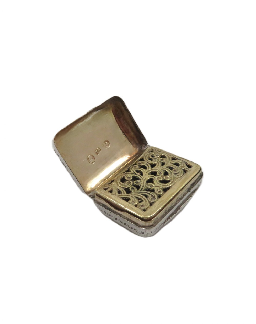 A small rectangular Georgian sterling silver vinaigrette box with detailed surface engraving and a central unengraved cartouche. View IV