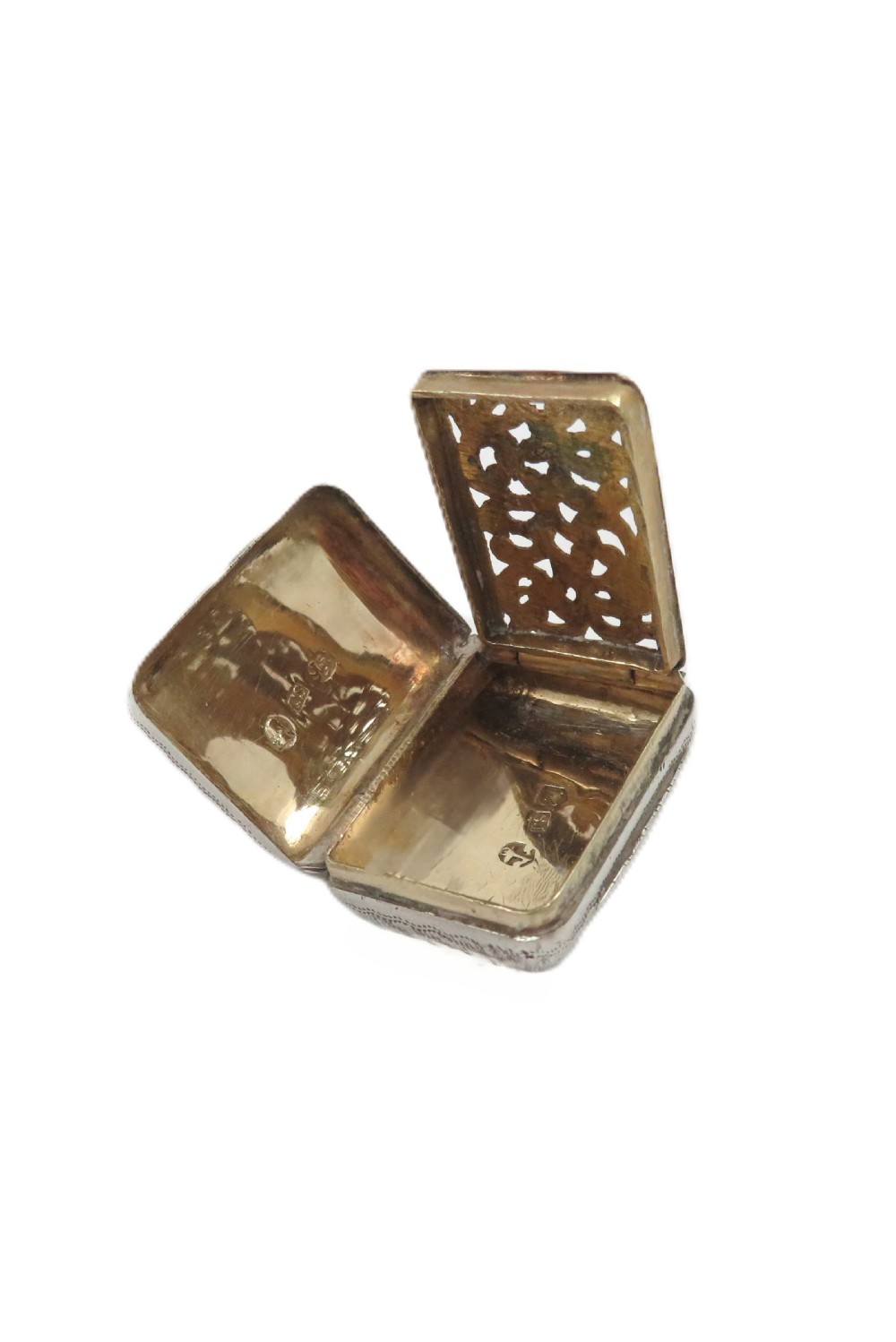 A small rectangular Georgian sterling silver vinaigrette box with detailed surface engraving and a central unengraved cartouche. View VI
