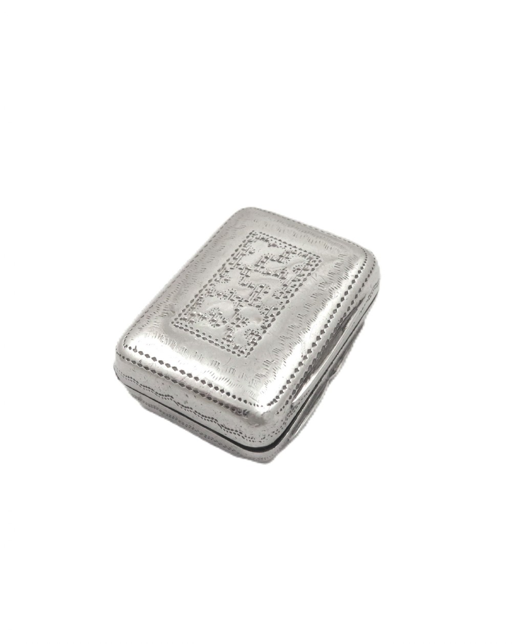 A small rectangular Georgian sterling silver vinaigrette box with detailed surface engraving and a central unengraved cartouche. View VII