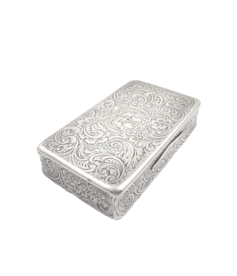 Rectangular sterling silver snuff box featuring intricate hand-engraved scrollwork and a central armorial cartouche on the hinged lid. View III